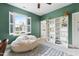 Comfortable bedroom featuring a beanbag chair, a window with plantation shutters, and a bookshelf with climbing plants at 1602 Bowery Dr, Raleigh, NC 27607