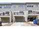 Rear exterior elevation featuring garages and decks at 1602 Bowery Dr, Raleigh, NC 27607