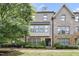 Attractive brick townhome featuring a covered porch and manicured landscaping at 1602 Bowery Dr, Raleigh, NC 27607