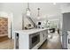 Open kitchen featuring a large island with seating, stainless appliances, and hardwood floors at 1602 Bowery Dr, Raleigh, NC 27607