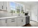 Bright kitchen featuring stainless steel appliances, white cabinets, and large window overlooking backyard at 1602 Bowery Dr, Raleigh, NC 27607