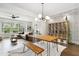 Open living room featuring hardwood floors, a large window, and stylish decor at 1602 Bowery Dr, Raleigh, NC 27607