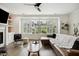 Comfortable living room with built-in fireplace and shelving with natural light from large window at 1602 Bowery Dr, Raleigh, NC 27607