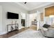 Cozy living room featuring guitars, a mounted TV, and comfortable seating at 1602 Bowery Dr, Raleigh, NC 27607