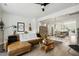 Open-concept living room with hardwood floors, leather sofa, and connected kitchen area at 1602 Bowery Dr, Raleigh, NC 27607
