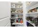 Walk-in pantry with white shelving to maximize storage and organization at 1602 Bowery Dr, Raleigh, NC 27607