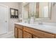 Bathroom featuring double sinks, wood cabinets, quartz counters, and modern fixtures at 161 Walking Path Pl, Hillsborough, NC 27278