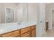 Bright bathroom with a modern vanity, solid surface countertop, and wood cabinets at 161 Walking Path Pl, Hillsborough, NC 27278