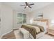 Cozy bedroom with neutral walls, wood-look floors, and a ceiling fan with a window view at 161 Walking Path Pl, Hillsborough, NC 27278