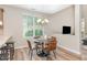Cozy dining area featuring a modern chandelier, window view, and seamless flow from kitchen at 161 Walking Path Pl, Hillsborough, NC 27278