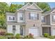 Attractive two-story townhome with a brick facade, complemented by tidy landscaping and an attached garage at 161 Walking Path Pl, Hillsborough, NC 27278