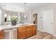 Well-appointed kitchen featuring wood cabinets, modern fixtures, and a view into the living space at 161 Walking Path Pl, Hillsborough, NC 27278