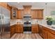Gourmet kitchen with custom cabinets, stainless steel appliances, and designer backsplash at 161 Walking Path Pl, Hillsborough, NC 27278