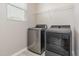 The laundry room features modern, stainless steel appliances and a bright window at 161 Walking Path Pl, Hillsborough, NC 27278