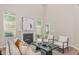 Bright living room with high ceilings, fireplace, neutral colors, and modern furnishings at 161 Walking Path Pl, Hillsborough, NC 27278