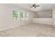 Carpeted loft area with large windows, neutral walls and lots of natural light at 161 Walking Path Pl, Hillsborough, NC 27278