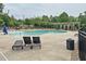 Inviting community pool area with lounge chairs and shaded pergola, perfect for relaxation and socializing at 161 Walking Path Pl, Hillsborough, NC 27278