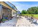 Large backyard featuring a patio, lounge chairs, lush lawn, and views of the surrounding trees at 173 Vinson Park Dr, Archer Lodge, NC 27527