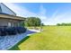 Expansive backyard with a paver patio, an outdoor kitchen, lush lawn, and lounge seating at 173 Vinson Park Dr, Archer Lodge, NC 27527