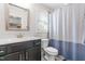 Functional bathroom with a dark vanity, white sink, and a shower and tub combination at 173 Vinson Park Dr, Archer Lodge, NC 27527
