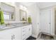 Bright bathroom with a granite double vanity, white cabinets and silver fixtures at 173 Vinson Park Dr, Archer Lodge, NC 27527