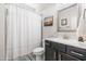 Well-lit bathroom with a vanity, mirror, and shower/tub combination at 173 Vinson Park Dr, Archer Lodge, NC 27527
