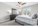Neutral colored bedroom with light walls, carpet, large window and dark gray dresser with mirror at 173 Vinson Park Dr, Archer Lodge, NC 27527