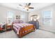 A light-filled bedroom featuring two windows, a ceiling fan, and neutral colored walls and carpet at 173 Vinson Park Dr, Archer Lodge, NC 27527