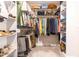 Walk-in closet featuring multiple shelves and hanging rods to maximize storage space at 173 Vinson Park Dr, Archer Lodge, NC 27527