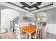 Cozy dining room with decorative ceiling beams, stylish pendant lighting, and a classic table set at 173 Vinson Park Dr, Archer Lodge, NC 27527