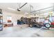 Spacious garage featuring ample storage with shelving, a utility trailer, and access to the backyard, ideal for hobbyists at 173 Vinson Park Dr, Archer Lodge, NC 27527