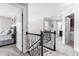 Open hallway with ornate wrought iron railing, carpet, and access to multiple rooms at 173 Vinson Park Dr, Archer Lodge, NC 27527