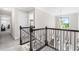 Second floor landing with ornate wrought iron railing, carpet, and great natural light at 173 Vinson Park Dr, Archer Lodge, NC 27527