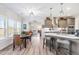Well-lit kitchen and breakfast nook featuring hardwood floors, an island with seating, and stainless steel appliances at 173 Vinson Park Dr, Archer Lodge, NC 27527