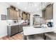 Well-equipped kitchen with modern appliances, bar stool seating, and stylish pendant lights at 173 Vinson Park Dr, Archer Lodge, NC 27527