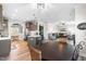 Bright open-concept living space featuring a kitchen with island, dining area, and living room with hardwood floors at 173 Vinson Park Dr, Archer Lodge, NC 27527