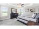 Bright main bedroom with tray ceiling, ceiling fan, and a matching dark dresser and mirror at 173 Vinson Park Dr, Archer Lodge, NC 27527