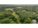 Expansive aerial view showcasing the home's setting amidst lush greenery and sprawling landscapes at 1837 Garrett House Trl, Burlington, NC 27215