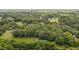 Picturesque aerial view revealing the home nestled among dense trees and tranquil surroundings at 1837 Garrett House Trl, Burlington, NC 27215