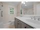 Updated bathroom with a double vanity, quartz countertop, and tiled shower and flooring at 1837 Garrett House Trl, Burlington, NC 27215