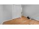 A simply designed bedroom with hardwood flooring, a closet, and light-colored walls at 1837 Garrett House Trl, Burlington, NC 27215