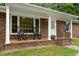 Inviting front porch with rocking chairs, perfect for relaxing outdoors at 1837 Garrett House Trl, Burlington, NC 27215