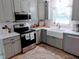 Bright kitchen with white countertops and stainless steel appliances at 1837 Garrett House Trl, Burlington, NC 27215