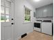 Bright laundry room featuring modern appliances and a window with a pleasant view at 1837 Garrett House Trl, Burlington, NC 27215