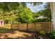 Serene backyard with a wooden fence and lush greenery, offering privacy and tranquility at 203 Brick St, Wake Forest, NC 27587