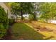 Fenced backyard with a well-maintained lawn and garden beds, great for outdoor activities at 203 Brick St, Wake Forest, NC 27587