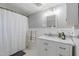 Bathroom featuring a shower with curtain and vanity with marble countertop at 203 Brick St, Wake Forest, NC 27587