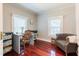 Bedroom with wood floors featuring a desk with chair and neutral color palette at 203 Brick St, Wake Forest, NC 27587