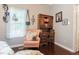 Charming bedroom with a cozy reading nook, hardwood floors, and natural light at 203 Brick St, Wake Forest, NC 27587