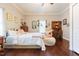 Comfortable bedroom with hardwood floors, personal library, and inviting decor at 203 Brick St, Wake Forest, NC 27587